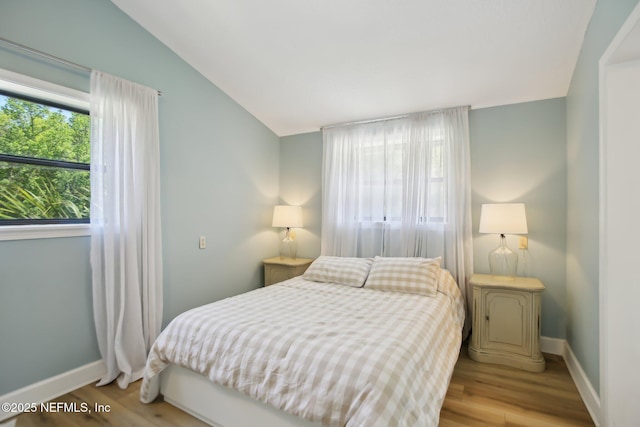 4068 Scenic Dr, Middleburg, FL 32068 - bedroom featuring vaulted ceiling, baseboards, and wood finished floors