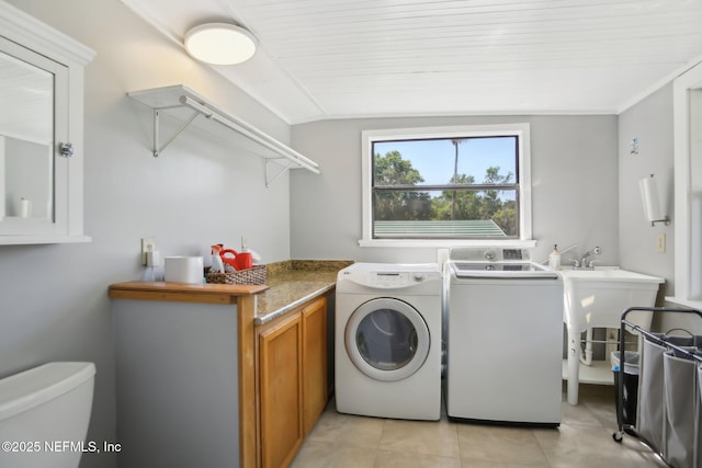 4068 Scenic Dr, Middleburg, FL 32068 - laundry room featuring washer and dryer, light tile patterned floors, and cabinet space
