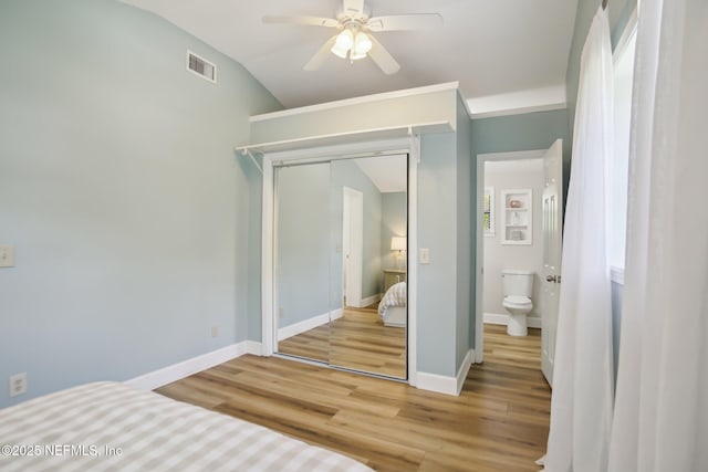 4068 Scenic Dr, Middleburg, FL 32068 - unfurnished bedroom with lofted ceiling, visible vents, a closet, baseboards, and light wood-style flooring