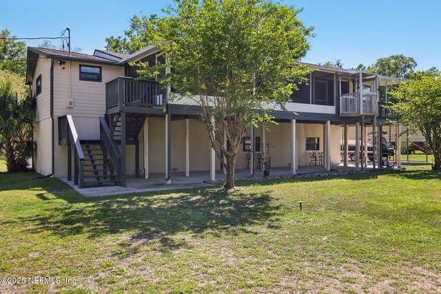 4068 Scenic Dr, Middleburg, FL 32068 - rear view of property featuring stairway, a yard, a patio, stucco siding, and a wooden deck