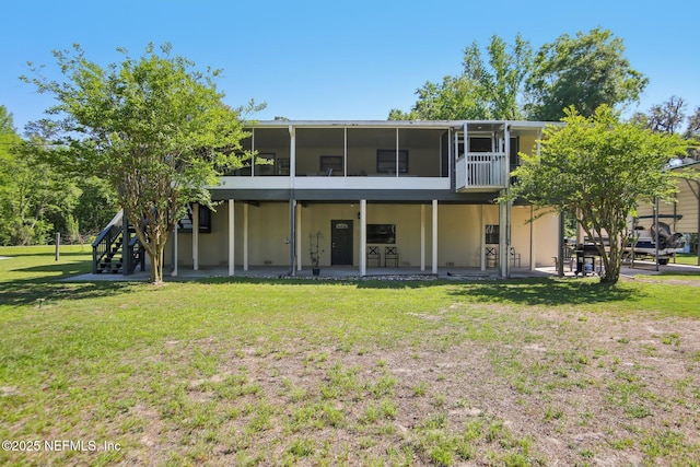 4068 Scenic Dr, Middleburg, FL 32068 - back of property featuring stucco siding, a sunroom, a yard, and a patio