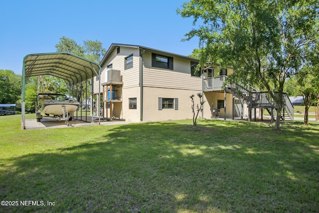 4068 Scenic Dr, Middleburg, FL 32068 - back of house with a carport, a deck, a yard, stucco siding, and stairs