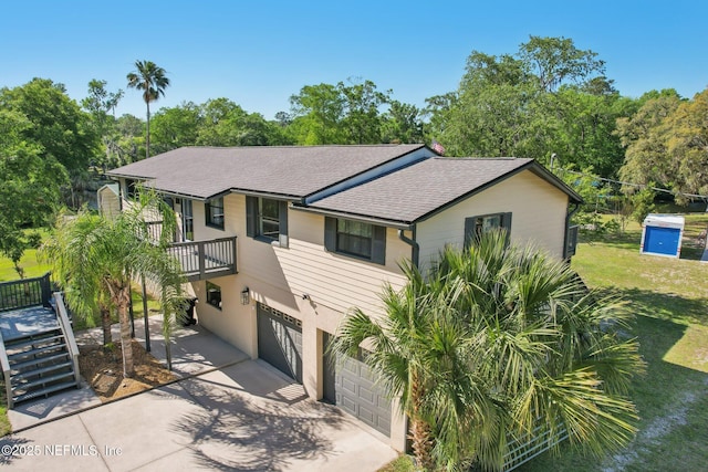 4068 Scenic Dr, Middleburg, FL 32068 - view of front of home featuring roof with shingles, concrete driveway, a garage, stairs, and a front yard
