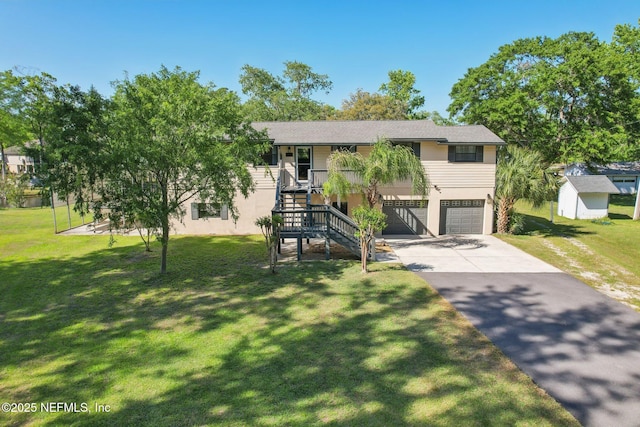4068 Scenic Dr, Middleburg, FL 32068 - view of front of home with a garage, concrete driveway, a front yard, stucco siding, and stairs