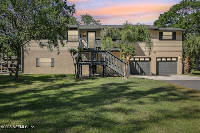 4068 Scenic Dr, Middleburg, FL 32068 - view of front of home with stairway, concrete driveway, a yard, a garage, and stucco siding