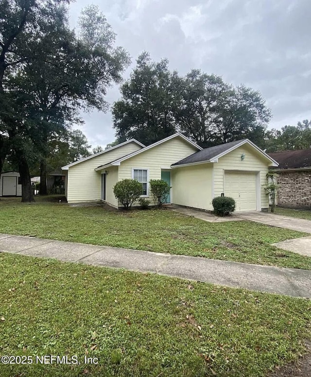 1422 Ellis Trace Dr, Jacksonville, FL 32205 - view of front of house featuring concrete driveway, an attached garage, and a front lawn
