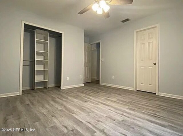 1422 Ellis Trace Dr, Jacksonville, FL 32205 - unfurnished bedroom with baseboards, wood finished floors, and visible vents