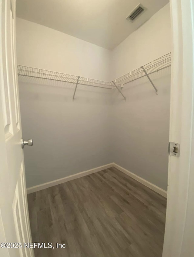 1422 Ellis Trace Dr, Jacksonville, FL 32205 - spacious closet with visible vents and dark wood-style floors