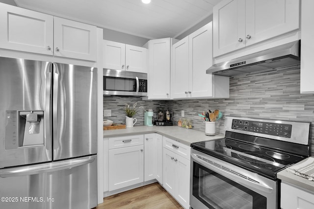 kitchen with under cabinet range hood, white cabinetry, appliances with stainless steel finishes, and light countertops