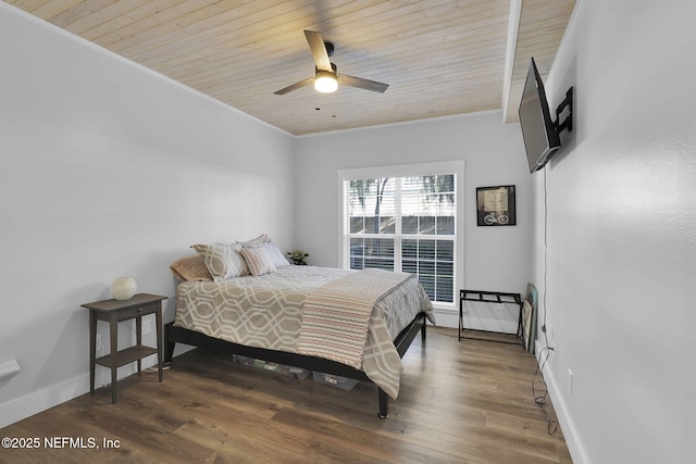 bedroom featuring ornamental molding, wood finished floors, and wood ceiling