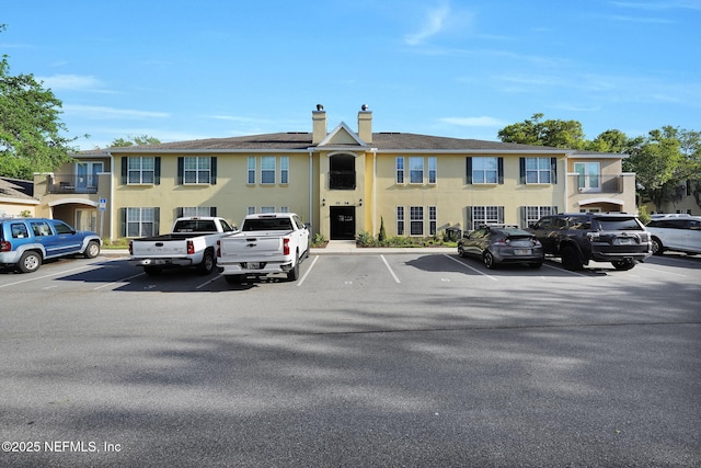 view of building exterior with uncovered parking