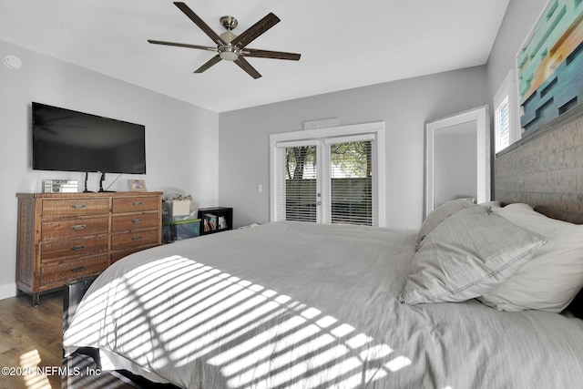 bedroom with wood finished floors, ceiling fan, and multiple windows