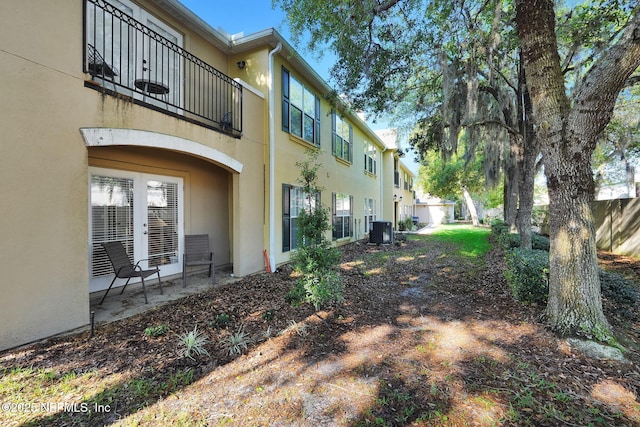 view of yard with a balcony and central AC unit