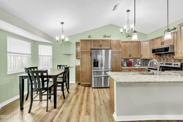 2925 Bradford St, Saint Augustine, FL 32084 - kitchen featuring an inviting chandelier, lofted ceiling, stainless steel appliances, and a sink