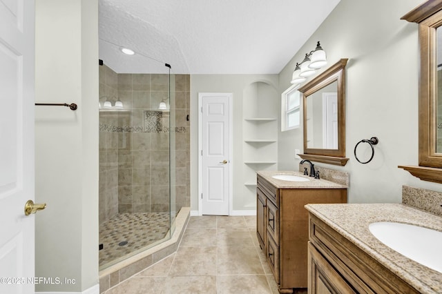 2925 Bradford St, Saint Augustine, FL 32084 - full bathroom featuring two vanities, a sink, a textured ceiling, and a stall shower