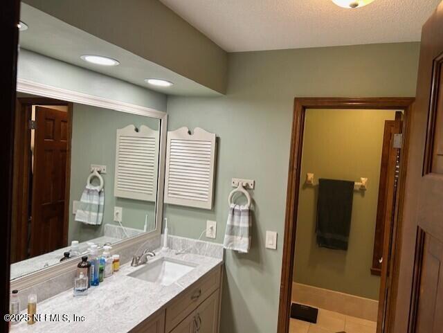 12186 Dividing Oaks Trl W, Jacksonville, FL 32223 - bathroom featuring tile patterned flooring, vanity, and baseboards