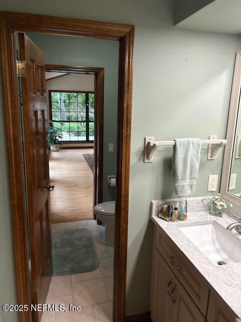 12186 Dividing Oaks Trl W, Jacksonville, FL 32223 - half bath with tile patterned flooring, toilet, and vanity