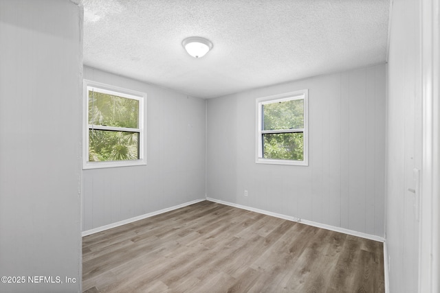 1585 W 31st St, Jacksonville, FL 32209 - unfurnished room featuring baseboards, wood finished floors, and a textured ceiling