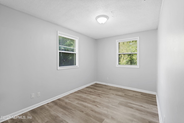 1585 W 31st St, Jacksonville, FL 32209 - empty room with baseboards, wood finished floors, and a textured ceiling