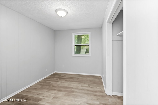 1585 W 31st St, Jacksonville, FL 32209 - unfurnished bedroom with baseboards, wood finished floors, and a textured ceiling
