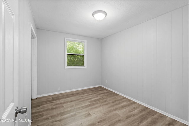1585 W 31st St, Jacksonville, FL 32209 - empty room featuring wood finished floors, a textured ceiling, and baseboards