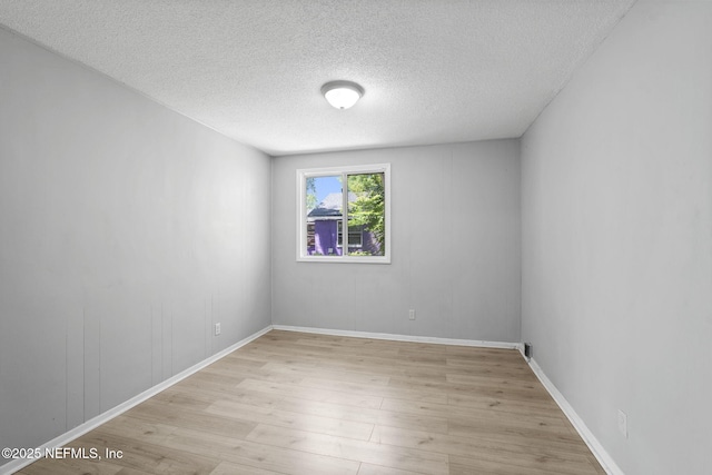 1585 W 31st St, Jacksonville, FL 32209 - unfurnished room featuring baseboards, light wood-style floors, and a textured ceiling
