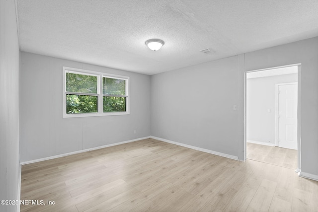 1585 W 31st St, Jacksonville, FL 32209 - empty room featuring baseboards, wood finished floors, and a textured ceiling