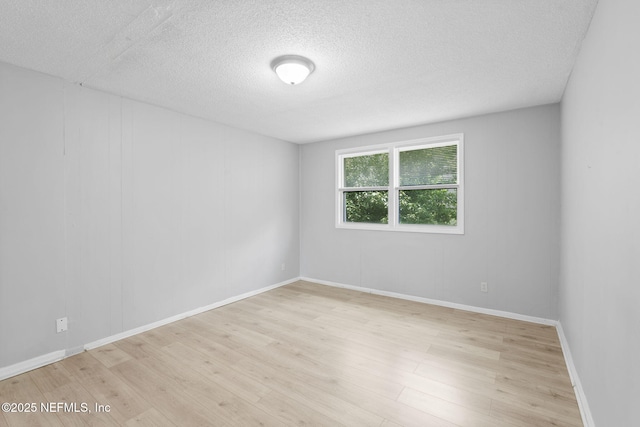 1585 W 31st St, Jacksonville, FL 32209 - empty room featuring baseboards, wood finished floors, and a textured ceiling