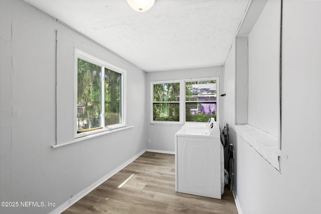 1585 W 31st St, Jacksonville, FL 32209 - clothes washing area featuring washing machine and clothes dryer, plenty of natural light, baseboards, and laundry area