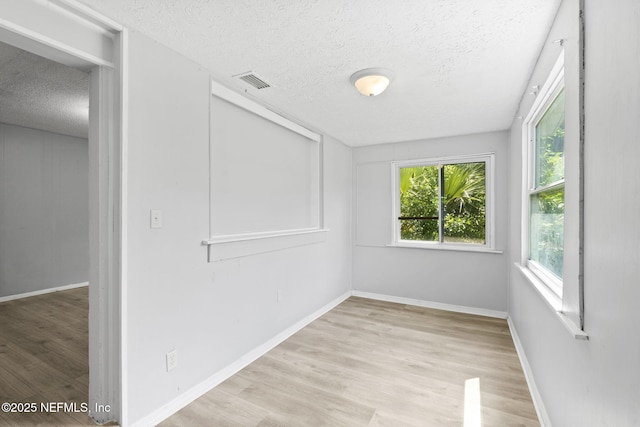 1585 W 31st St, Jacksonville, FL 32209 - unfurnished room featuring baseboards, wood finished floors, a textured ceiling, and visible vents