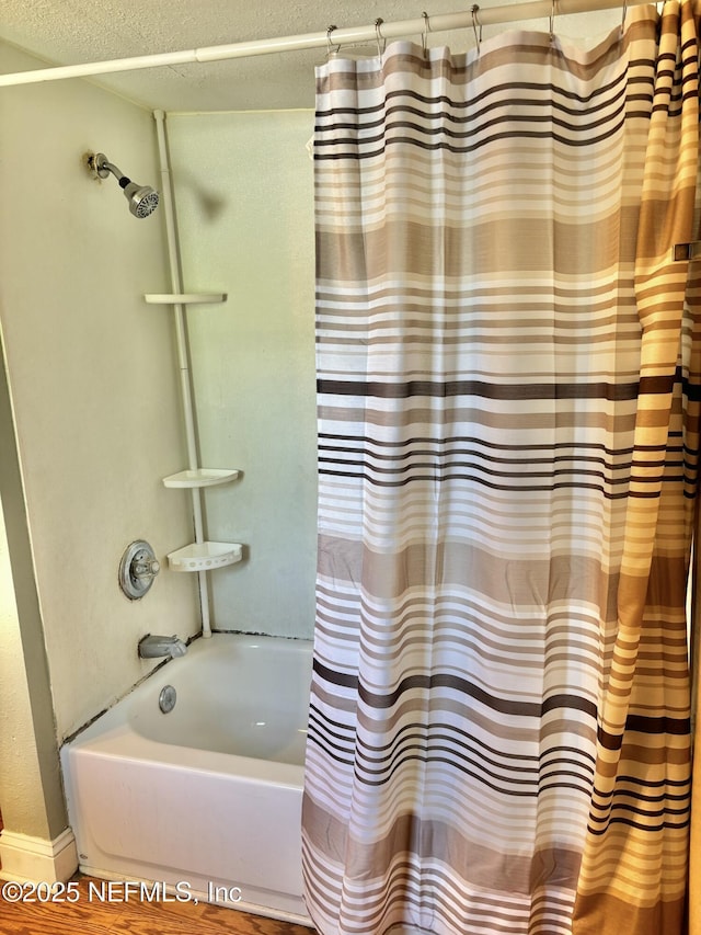 2027 W 12th St, Jacksonville, FL 32209 - bathroom with baseboards and shower / bath combo with shower curtain