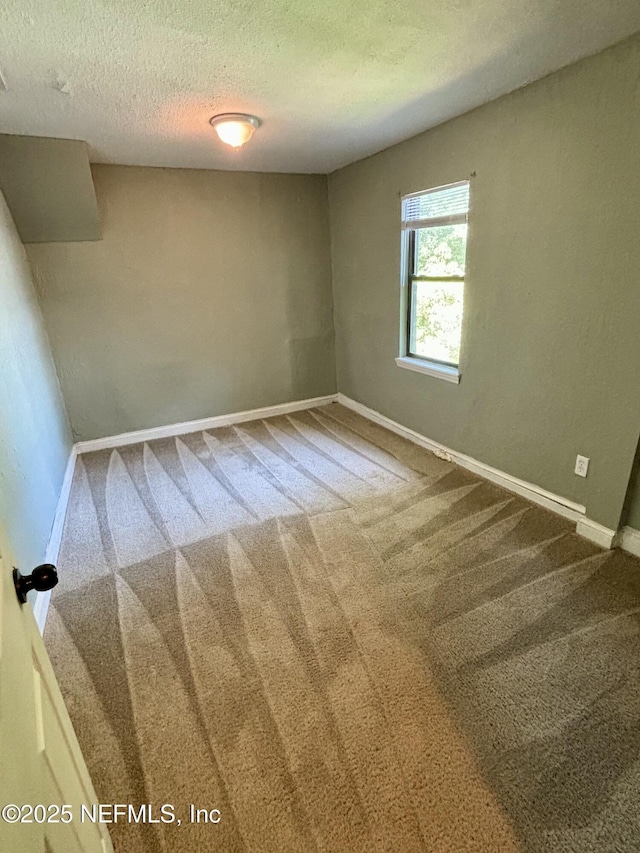2027 W 12th St, Jacksonville, FL 32209 - unfurnished room featuring baseboards, carpet flooring, and a textured ceiling