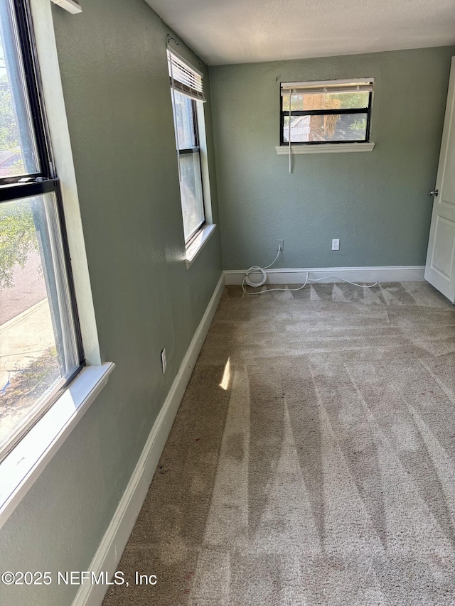 2027 W 12th St, Jacksonville, FL 32209 - unfurnished bedroom with baseboards, multiple windows, and carpet