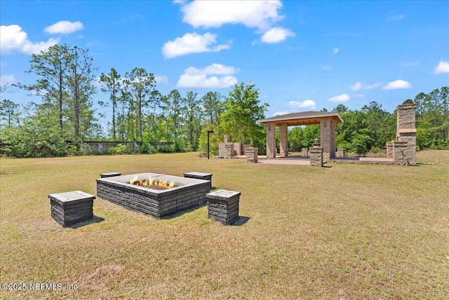surrounding community with a fire pit, a gazebo, and a yard