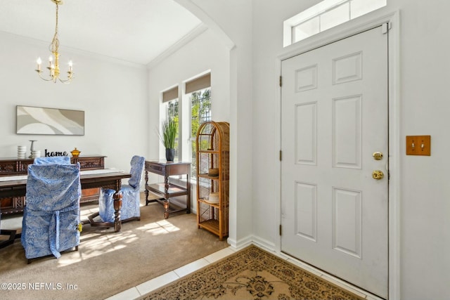 entrance foyer with arched walkways, carpet, a notable chandelier, tile patterned flooring, and crown molding