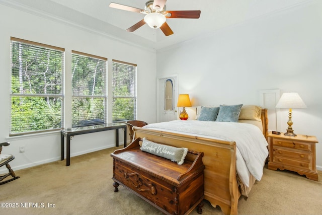 bedroom with multiple windows, baseboards, and light carpet