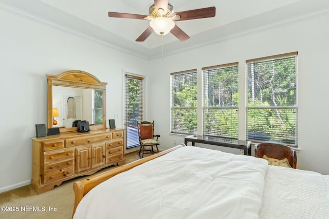 bedroom with ceiling fan, baseboards, light colored carpet, and ornamental molding
