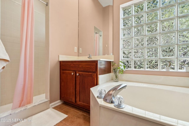 full bath featuring a bath, vanity, tile patterned floors, and a stall shower