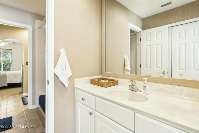 ensuite bathroom featuring ensuite bathroom, visible vents, tile patterned flooring, a shower, and vanity