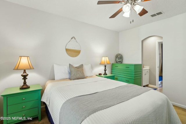 bedroom featuring arched walkways, baseboards, visible vents, a ceiling fan, and carpet floors