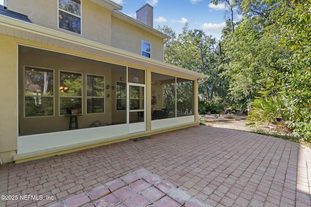 view of patio with a sunroom