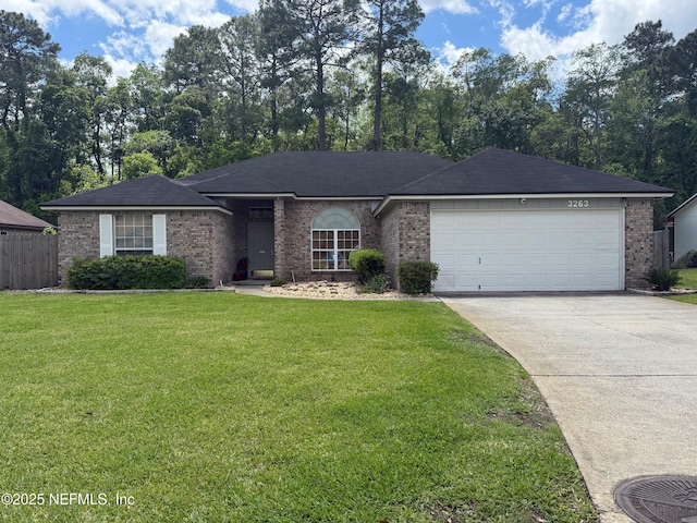 ranch-style house with fence, brick siding, a garage, a front yard, and driveway