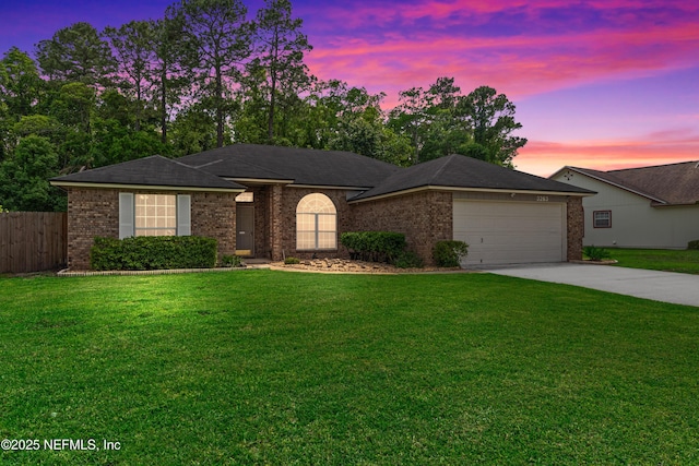 single story home featuring concrete driveway, brick siding, an attached garage, and fence