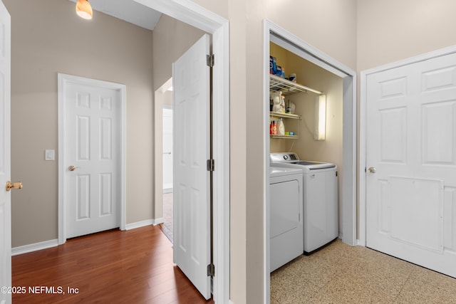 laundry room featuring washer and dryer, laundry area, baseboards, and wood finished floors