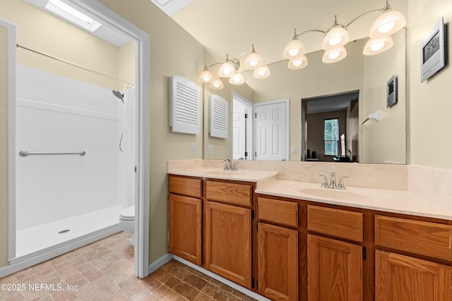 full bathroom with a sink, a shower with curtain, toilet, and double vanity