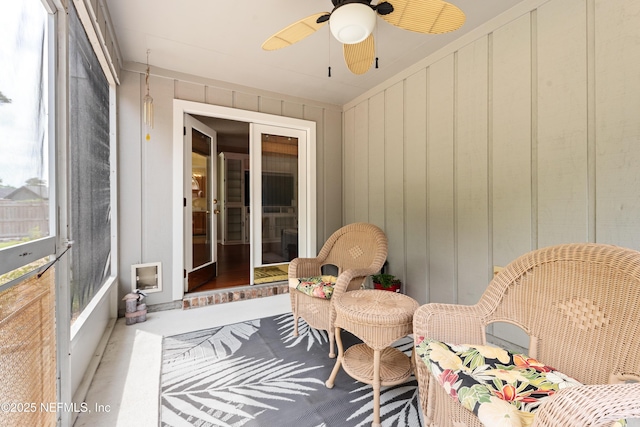 sunroom / solarium featuring ceiling fan