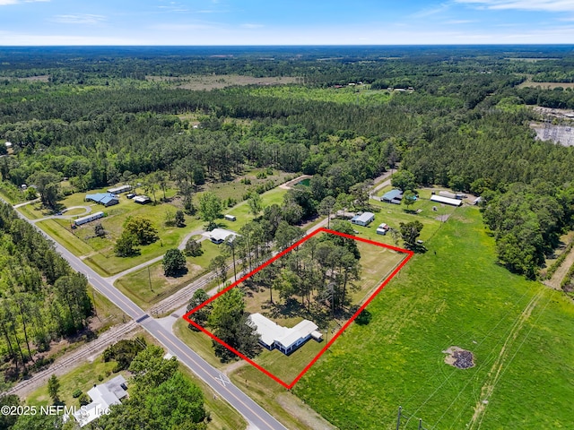 birds eye view of property featuring a wooded view
