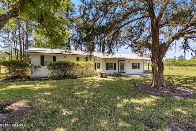 ranch-style home with a front lawn and metal roof