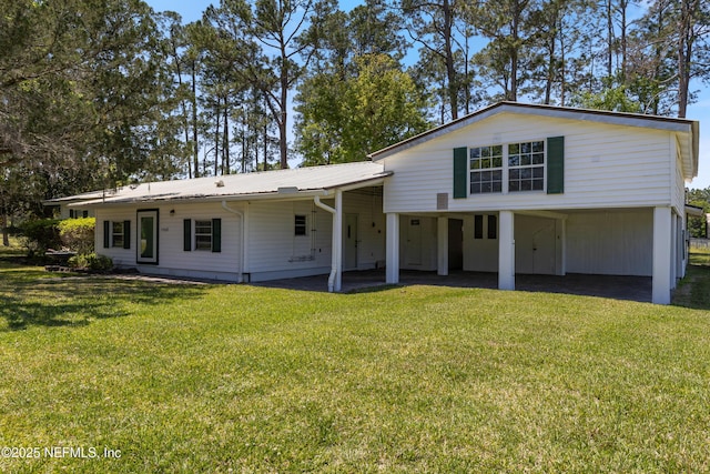 view of front facade with a front yard and metal roof