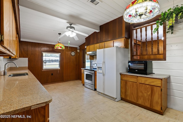 kitchen with a sink, stainless steel electric range, vaulted ceiling with beams, wooden walls, and white fridge with ice dispenser